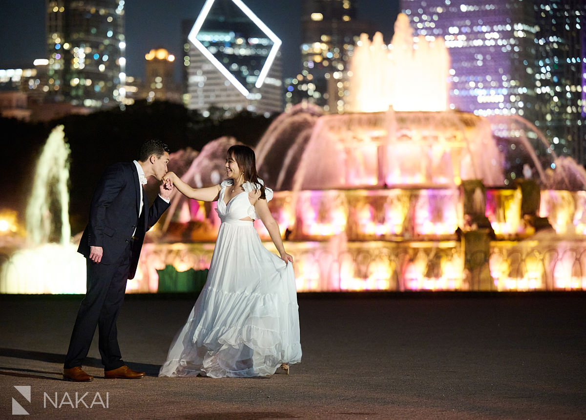 chicago buckingham fountain engagement night time photos kiss on hand